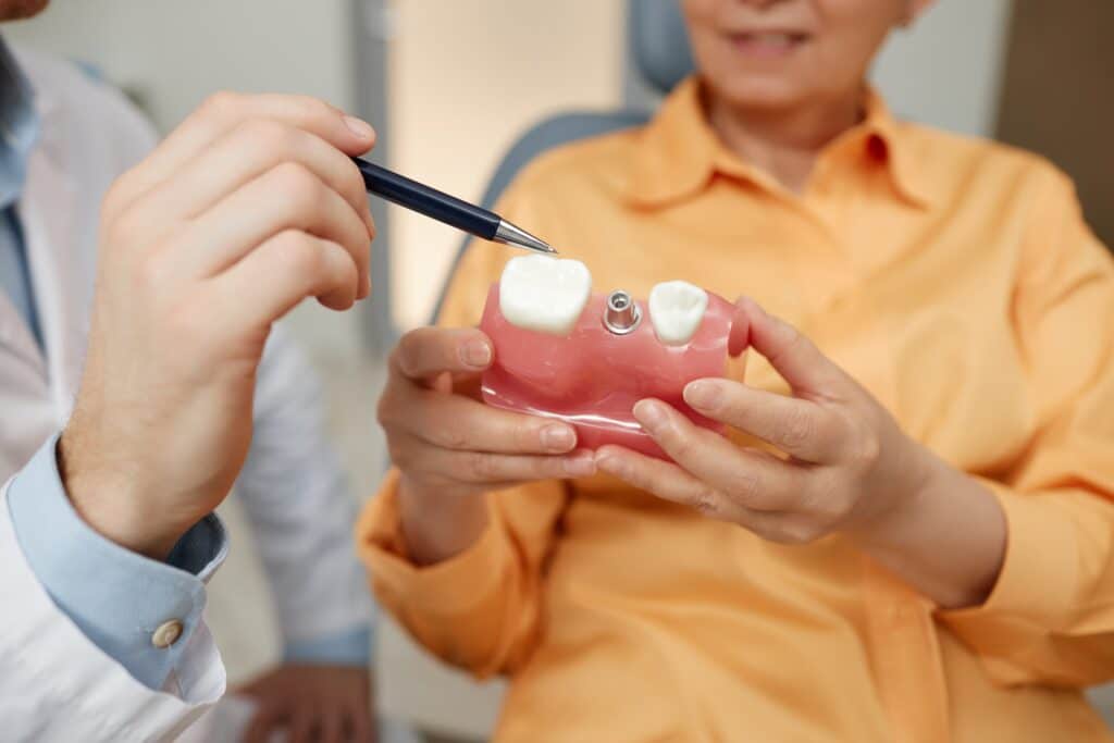 Older patient having a consultation with her dentist about how Snap-on Dentures work