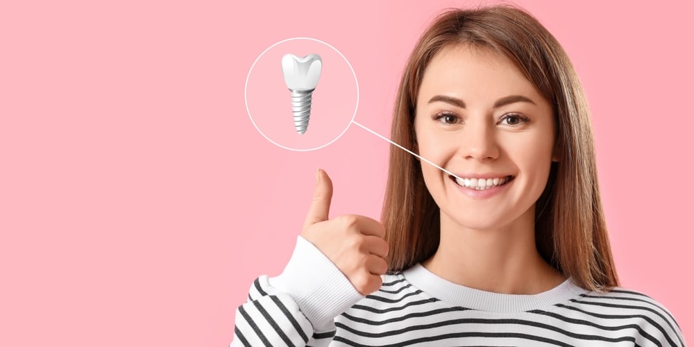 Smiling woman with a close up of a dental implant to show how her teeth were repaired.